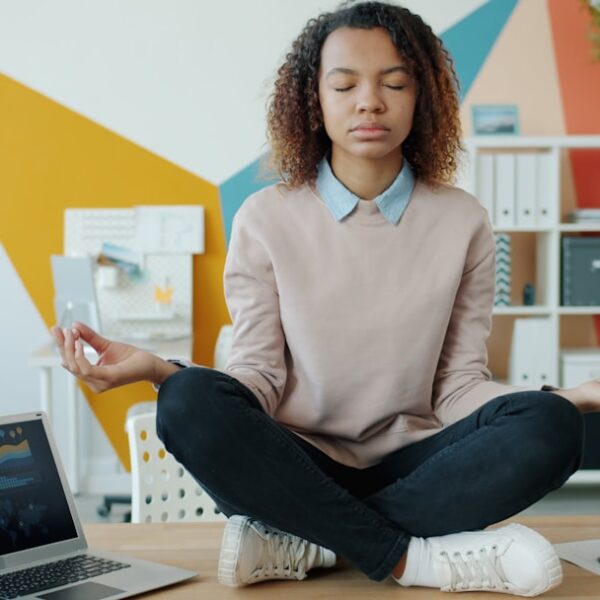A professional taking a restorative pause at a desk as part of a balanced ADHD routine