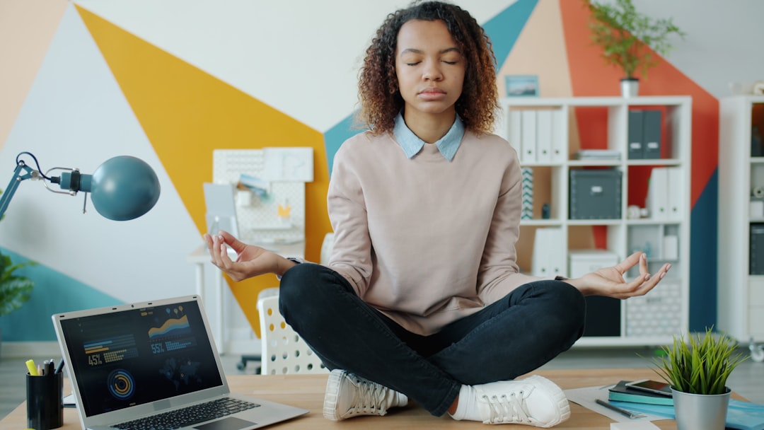 A professional taking a restorative pause at a desk as part of a balanced ADHD routine