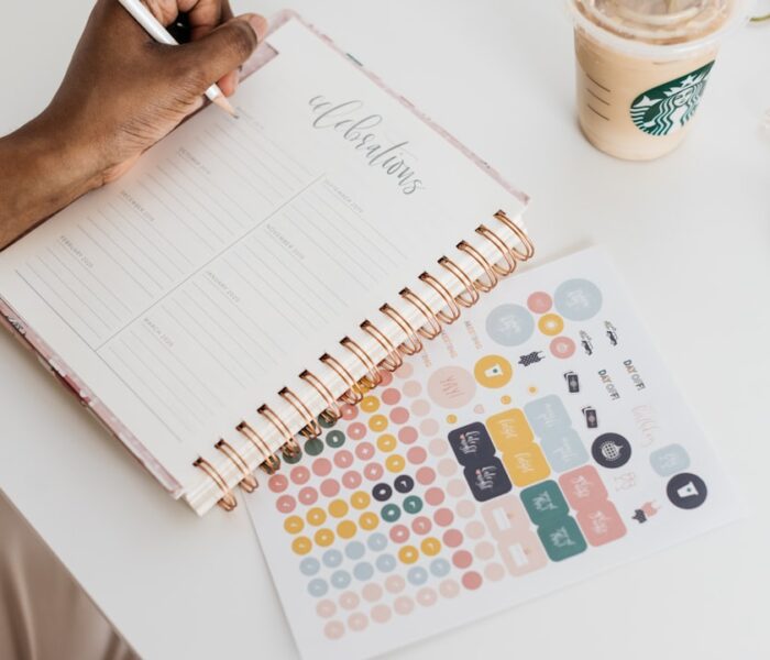 A person using a planner to organize tasks and support focus