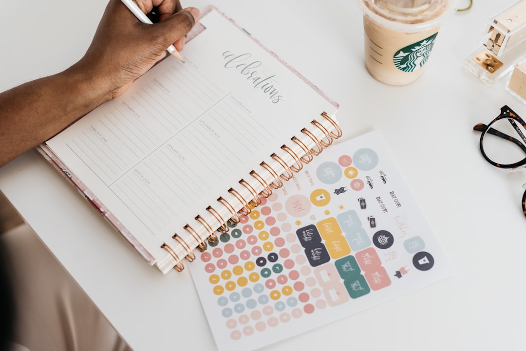 A person using a planner to organize tasks and support focus