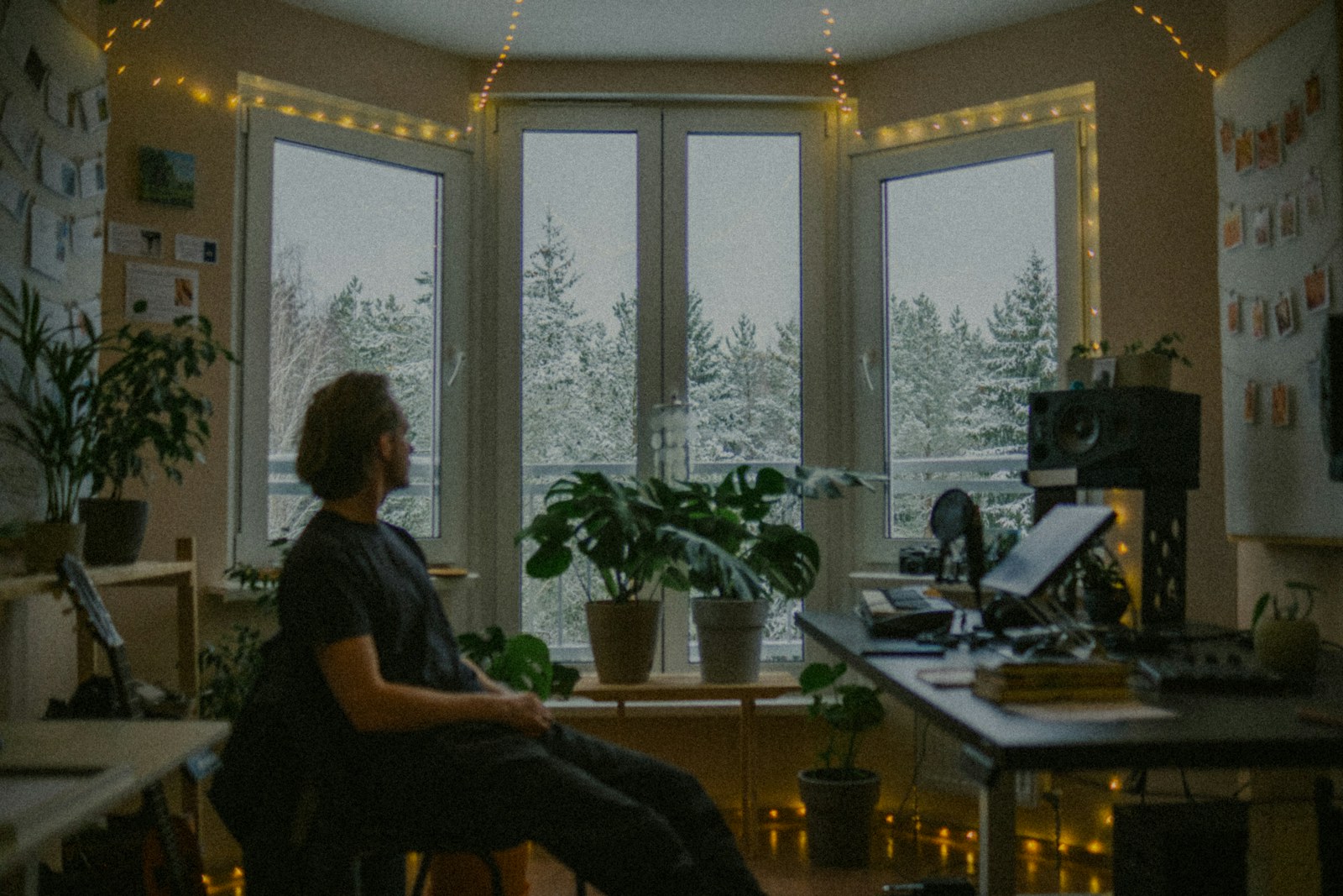 A person pausing in a calm room and looking through a window