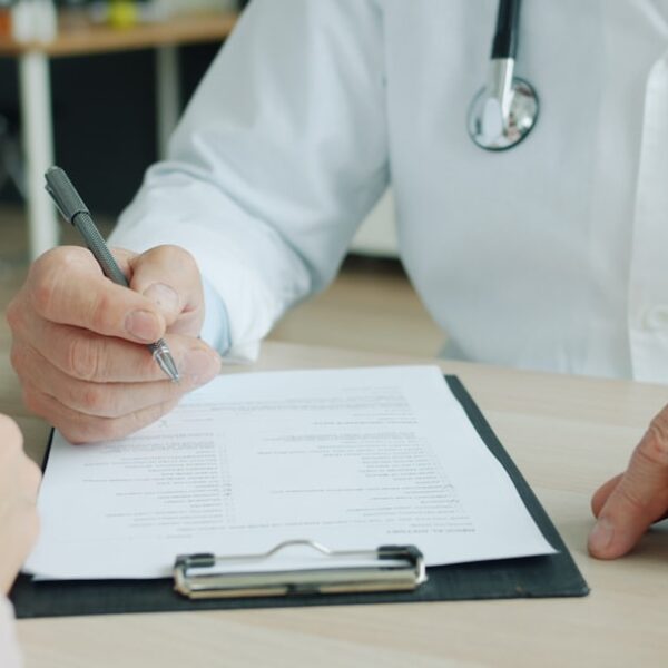 A clinician listening to an adult patient during a thoughtful psychiatric evaluation