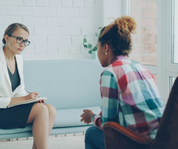 A mental health professional listening carefully during a private consultation