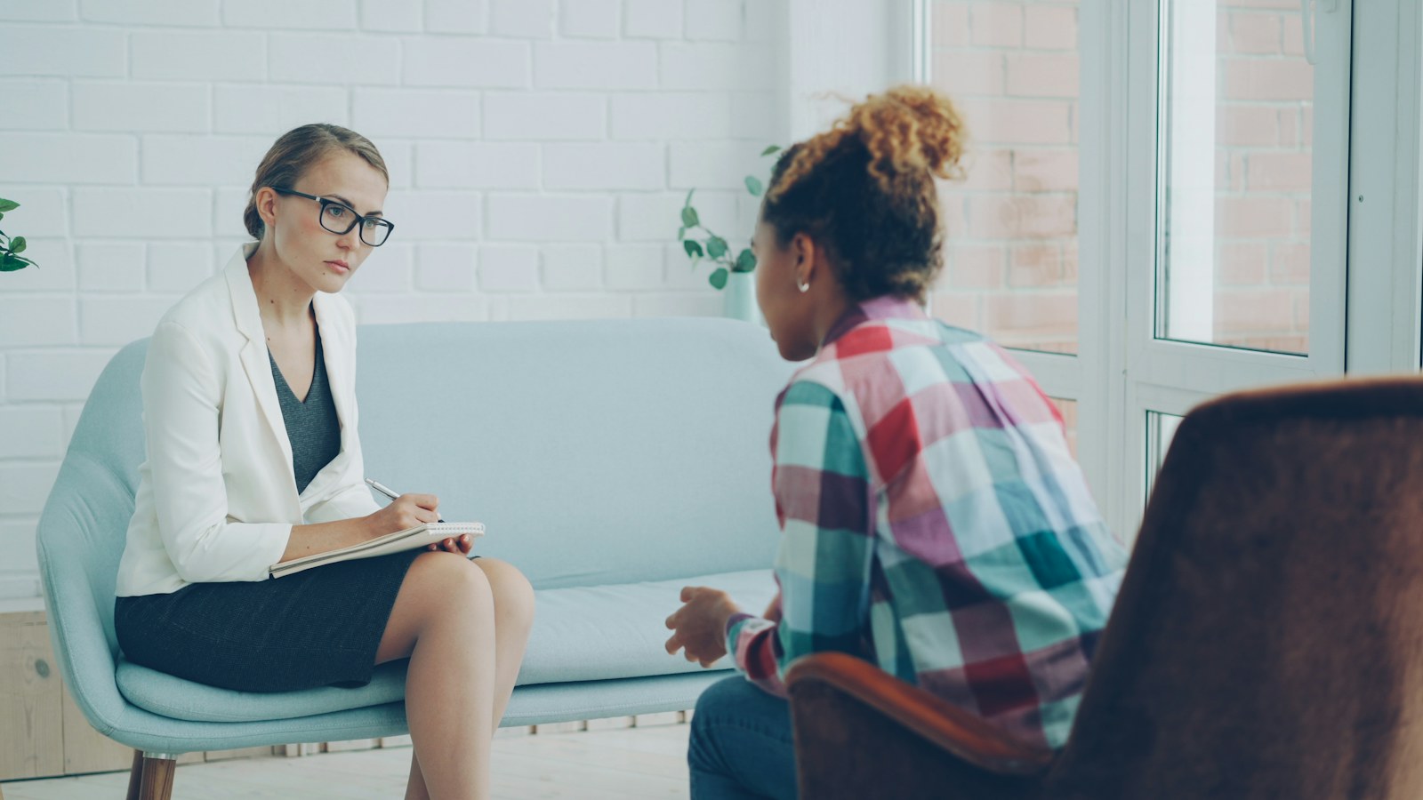 A mental health professional listening carefully during a private consultation
