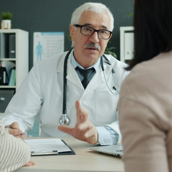 A clinician meeting with a parent and teenager to discuss supportive mental health care