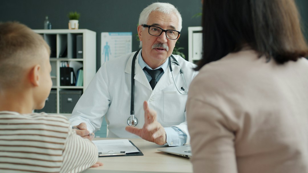 A clinician meeting with a parent and teenager to discuss supportive mental health care